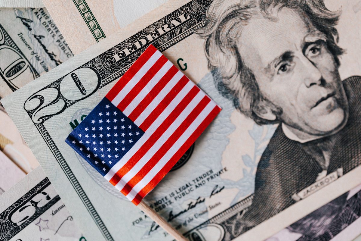 Person reviewing budget and spending tracker on phone and laptop — Money Manager feature